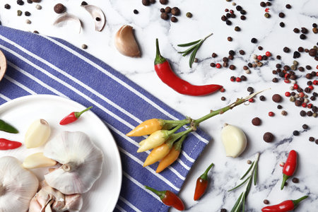 Flat lay composition with garlic and peppers on marble tableの写真素材