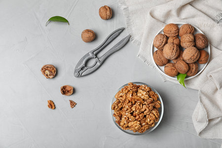 Flat lay composition with walnuts on gray background