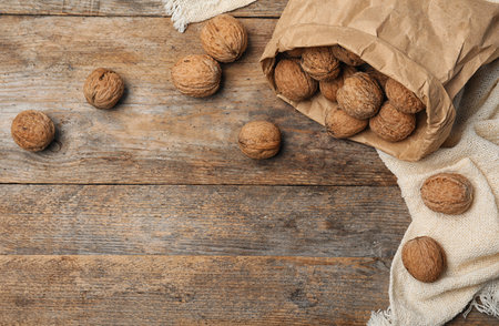 Flat lay composition with walnuts and space for text on wooden backgroundの写真素材