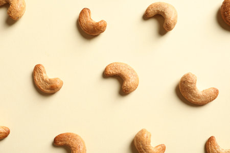 Tasty cashew nuts on light background, flat layの写真素材