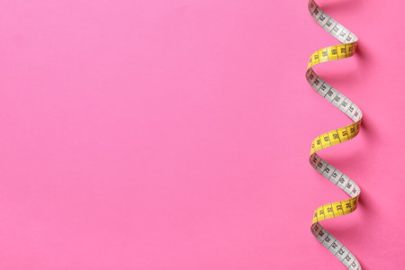 Measuring tape and space for text on color background, top view. weight loss conceptの写真素材