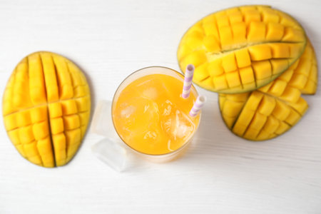 Fresh mango drink and fruits on table, top viewの写真素材