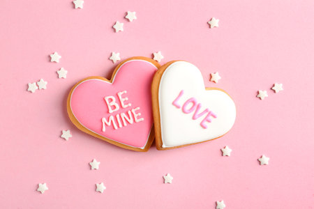 Composition with decorated heart shaped cookies on color background, top view. Valentine's day treatの写真素材