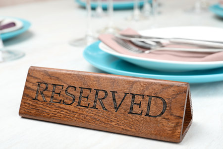 Table setting with RESERVED sign in restaurantの写真素材
