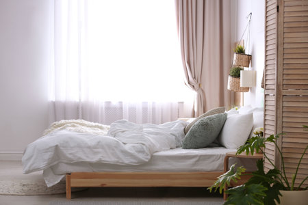 Stylish apartment with large comfortable bed. room interiorの写真素材