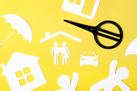 Flat lay composition with paper silhouette of family and scissors on color background. life insurance conceptの写真素材