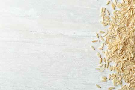 Brown rice on wooden background, top view with space for textの写真素材