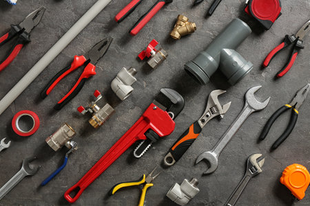 Flat lay composition with plumber's tools on gray backgroundの写真素材