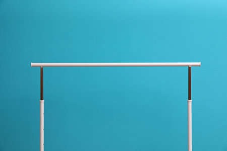 Empty wardrobe rack for clothes on color background
