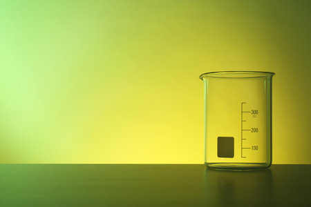 Empty beaker on table against color background. Chemistry laboratory glasswareの写真素材