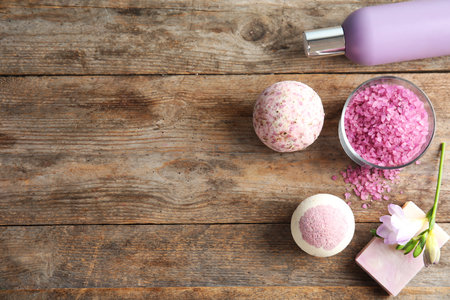 Flat lay composition with bath bombs, toiletries and space for text on wooden backgroundの写真素材
