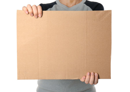 Woman holding piece of cardboard on white background, closeup. Space for textの写真素材