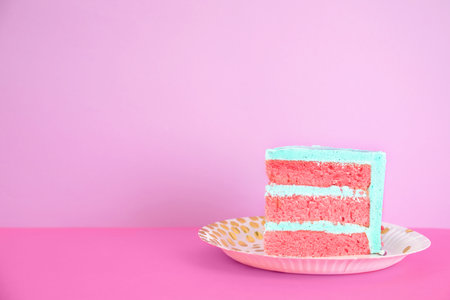Slice of fresh delicious birthday cake on table against color background. Space for textの写真素材