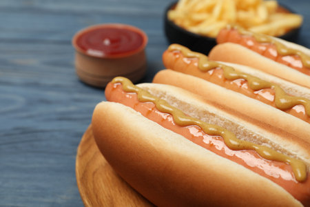 Fresh hot dogs with mustard on wooden table, closeupの写真素材