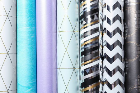 Rolls of festive wrapping paper as background, top view. gift box packaging ideasの写真素材