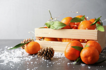 Christmas composition with ripe tangerines and artificial snow on table. Space for textの写真素材