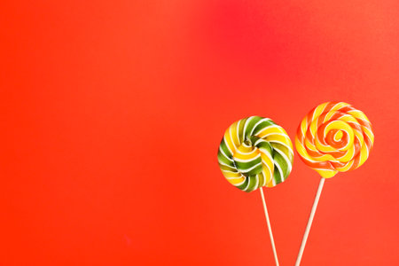 Bright yummy candies on color background. Space for textの写真素材