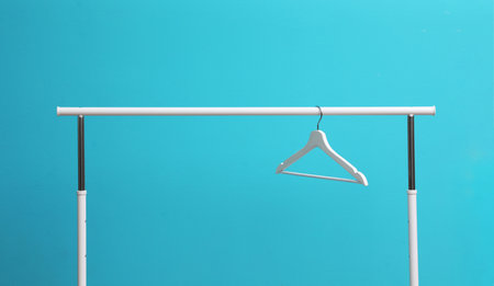 Wardrobe rack with hanger on color backgroundの写真素材