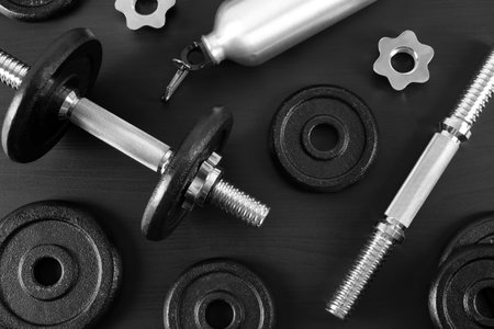 Flat lay composition with dumbbell and parts on dark wooden backgroundの写真素材