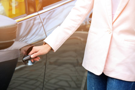 Close up view of woman opening car doorの写真素材