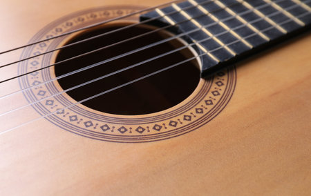 Closeup view of acoustic guitar, focus on hole soundの写真素材