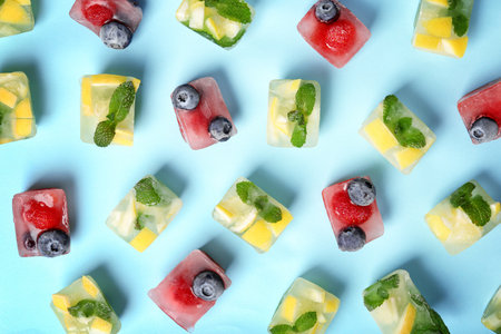 Flat lay composition with fruit and berry ice cubes on color backgroundの写真素材