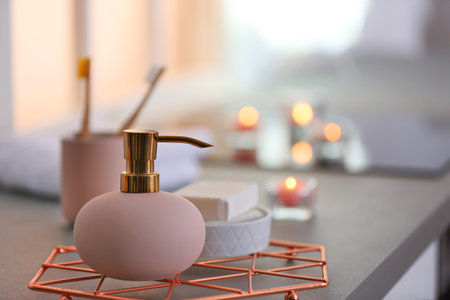 Bottle with liquid soap and toiletries on table against blurred background. Space for textの写真素材