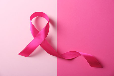 Pink ribbon and space for text on color background. breast cancer awareness conceptの写真素材
