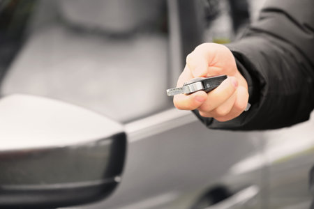 Close up view of man opening car door with keyの写真素材