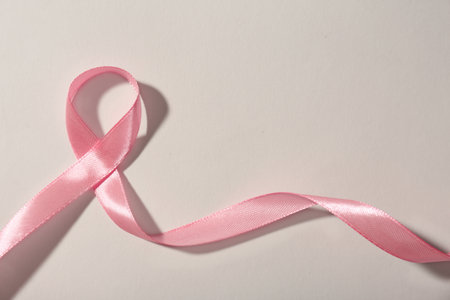 Pink ribbon and space for text on gray background. breast cancer awareness conceptの写真素材