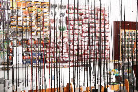 Stand with different fishing rods in sports shopの写真素材