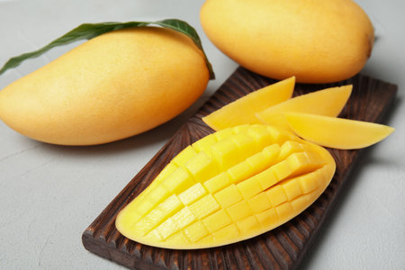 Ripe juicy mango on gray table. tropical fruitsの写真素材