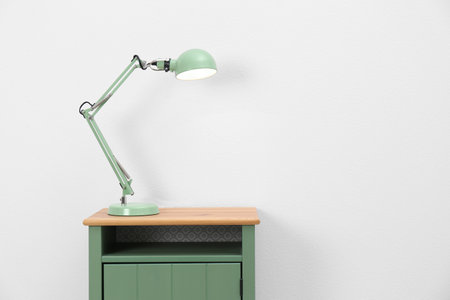 Stylish lamp on table against white background. Space for textの写真素材