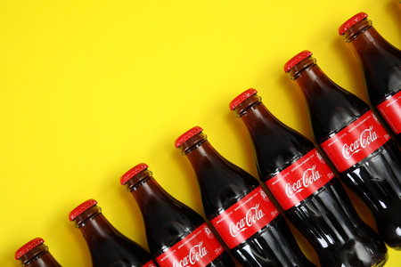 MYKOLAIV, UKRAINE - NOVEMBER 14, 2018: Bottles of Coca-Cola on color background, flat lay. Space for textのeditorial素材