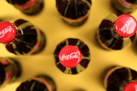 MYKOLAIV, UKRAINE - NOVEMBER 14, 2018: Bottles of Coca-Cola on color background, top view