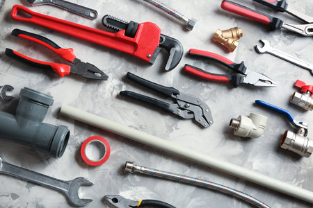 Flat lay composition with plumber's tools on gray backgroundの写真素材