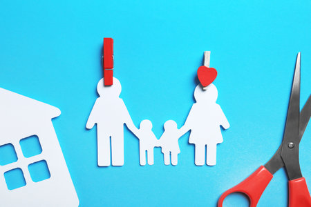 Paper silhouettes of family with pins, house and scissors on color background, flat lay. life insurance conceptの写真素材