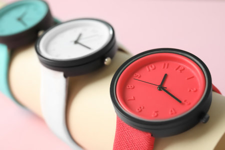 Holder with collection of stylish wrist watches on color background. fashion accessoryの写真素材