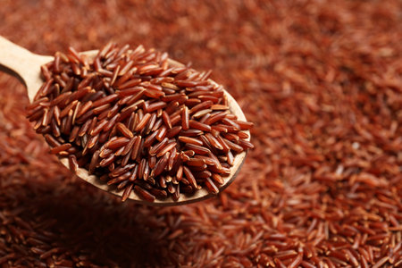 Brown rice in wooden spoon, closeup viewの写真素材