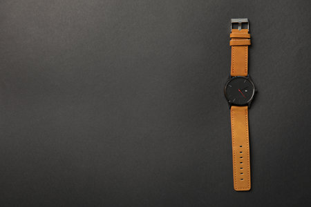 Stylish wrist watch on dark background, top view with space for text. fashion accessoryの写真素材