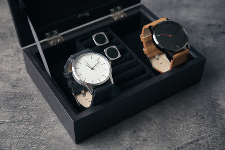 Case with stylish wrist watches on gray background. fashion accessoryの写真素材
