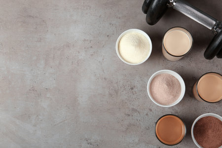 Flat lay composition with protein shakes in glasses and space for text on tableの写真素材