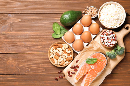 Set of natural food high in protein and space for text on wooden background, top viewの写真素材