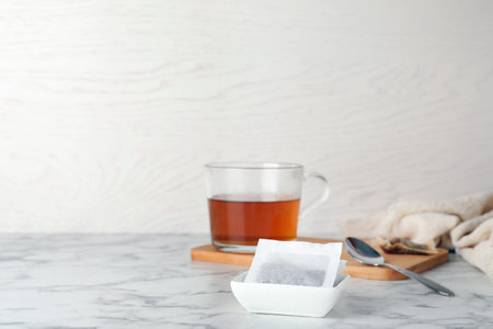 Bowl with tea bags on table. Space for textの写真素材