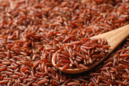 Wooden spoon with raw brown rice on cereal, closeup viewの写真素材