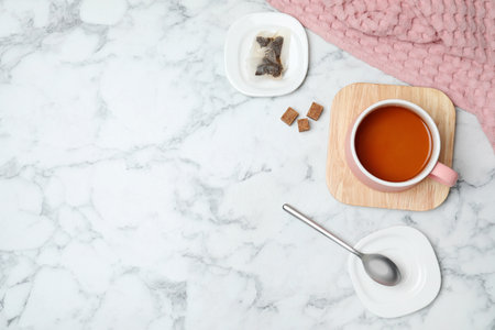 Flat lay composition with delicious hot tea and space for text on marble backgroundの写真素材