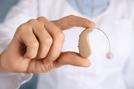 Doctor holding hearing aid, closeup. medical deviceの写真素材