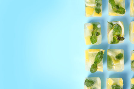 Flat lay composition with lemon and mint ice cubes on color background. Space for textの写真素材