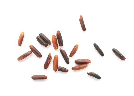 Scattered grains of brown rice on white background, top viewの写真素材