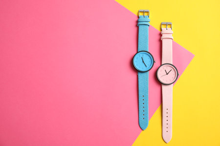 Flat lay composition with stylish wrist watches and space for text on color background. fashion accessoriesの写真素材